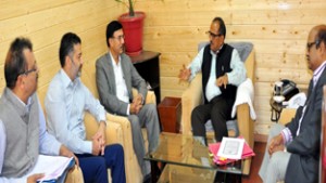 Deputy CM Dr Nirmal Singh interacting with officers in a meeting at Srinagar on Tuesday.