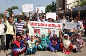 Dogra Labour Union activists protesting in front of Press Club Jammu on Monday. —Excelsior/Rakesh