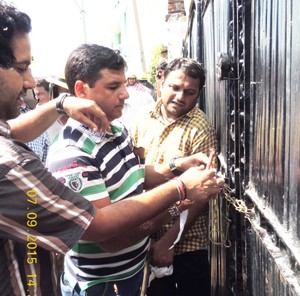 Forest officials sealing illegal saw mill.