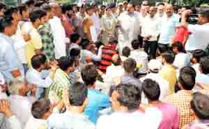 Provincial President NC, Devender Singh Rana interacting with agitating people at Nagrota on Tuesday.