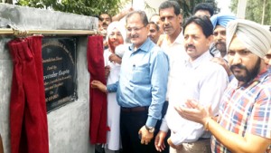 Kavinder Gupta laying foundation of upgradation of road at Satwari on Friday.