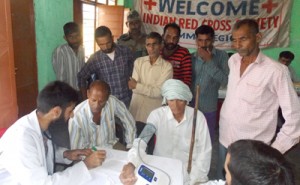 Doctor examining villagers during free medical camp by Red Cross on Wednesday.