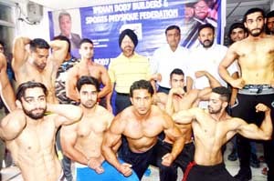 Players posing alongwith office bearers of the Association during weighing process of Mr Jammu Body Building Championship.