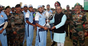 Deputy CM presenting winner trophy to skipper of Damana Jagaurs in Jammu on Monday.