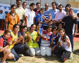 Jubilant players of Braham Rishi Bawra Handball Club posing along with dignitaries after clinching Handball title in Udhampur on Monday.