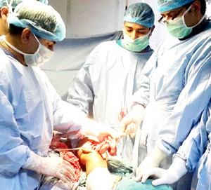 Dr Sanjeev Gupta and others performing rare knee replacement at GMC Jammu.