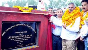 Minister for PHE, Ch Sukhnandan laying foundation stone of black topping of road from Baba-da-Talab to Jhiri on Sunday.