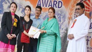 MoS Education, Priya Sethi presenting certificate to a rank holder during Award Ceremony by DJSES on Saturday.