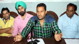 President PHE Daily Wagers Association, Tanveer Hussain addressing press conference in Jammu on Tuesday.  -Excelsior/Rakesh 