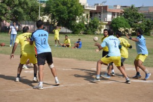 Players in action during a match of Jammu District Handball Championship at Shastri Nagar Playfield in Jammu on Tuesday.