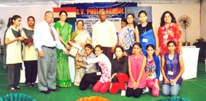 Students of New Era Environmental School receiving memento from the dignitaries.