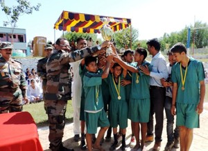 Winners of Volleyball Competition being presented trophy by Army Officer at Bajabain in Sunderbani on Thursday.