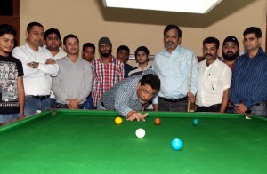 Chairman JKBSA, Sidharth Sharma aiming at target while inaugurating 23rd Jammu District Open Jr, Sr Billiards & Snooker Championship in Jammu. -Excelsior/Rakesh