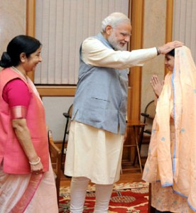 Geeta, a deaf-mute Indian girl who accidentally crossed over to Pakistan, a decade ago, meeting the Prime Minister, Narendra Modi after her return to India, in New Delhi on Monday. External Affairs and Overseas Indian Affairs Minister, Sushma Swaraj  is also seen in the picture.(UNI)