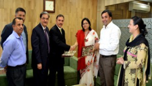 J&K Bank and Bajaj Allianz officers signing MoU during a function in Srinagar on Saturday.