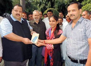 MLA Nagrota Devender Singh Rana providing Tablet to a girl student on Sunday. 