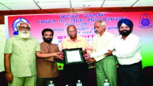 Dignitaries felicitating ND Jamwal during Jharokha-8 at K L Saigal Hall on Sunday.