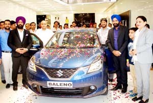 Officials of Nexa Peaks Auto unveiling premium hatchback ‘Baleno’ at Jammu on Monday. -Excelsior/Rakesh