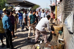 JMC officials removing encroachments from Gumat area on Friday.