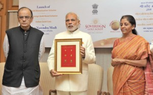 Prime Minister Narendra Modi launches the Gold schemes, in New Delhi on Thursday. Union Minister for Finance, Corporate Affairs and Information and Broadcasting, Arun Jaitley and Minister of State for Commerce and Industry (I/C),Nirmala Sitharaman also seen in the picture. (UNI)