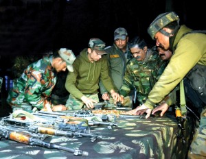 Army jawans display arms and ammunition recovered from slain militants at Tangdhar on Wednesday. -Excelsior/Aabid Nabi