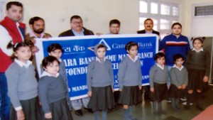 Canara Bank management and staff donating almirahs to orphanage at Jammu on Thursday.