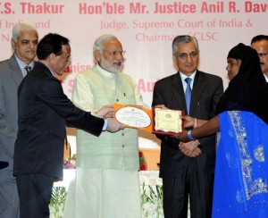 Prime Minister Narendra Modi felicitating the best district legal service authority and para-legal volunteers from each region and national level, at National Legal Service Day and Commendation Ceremony, in New Delhi on  Monday.   Supreme Court judge and Executive Chairman NALSA, Justice T.S. Thakur is  also seen. (UNI)