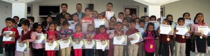 MVEANs posing for a group photograph while displaying certificates and medals.