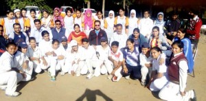 Participating girls from the districts of Jammu, Srinagar and Kishtwar posing for a group photograph alongwith the officials during the inaugural ceremony of Inter-District U-17 Girls Cricket Tournament in Jammu on Monday.   