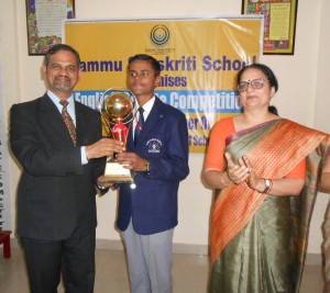 Trilok Singh Bist presenting trophy to a winner of Inter School English Debate Competiton.