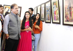 Speaker J&K Legislative Assembly, Kavinder Gupta evincing keen interest at the paintings during painting exhibition at Kala Kendra in Jammu.    -Excelsior/Rakesh   