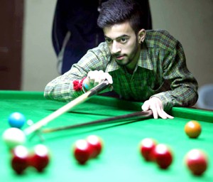 Cueist Rahul Chib aiming a shot during final match of Junior Snooker Championship.—Excelsior/Rakesh