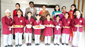 Students of Stephens International School posing for group photograph as chefs during 'Fireless Cooking Activity'. 