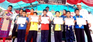 Students displaying certificates while posing for a group photograph during Annual Sports Day at KV-1 Udhampur on Friday.
