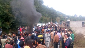 Irate villagers blocking road at Narian near Chingus in Rajouri on Thursday. 