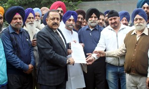 Union Minister Dr Jitendra Singh receiving a memorandum from a delegation of PoJK refugees at Jammu on Thursday.