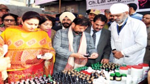 Minister for Health, Ch Lal Singh flanked by MoS for Education, Priya Sethi during Health Mela at Rajinder Bazar on Monday.