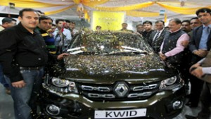 Speaker, Legislative Assembly, Kavinder Gupta alongwith officials of Renault Jammu unveiling Renault Kwid at Jammu on Friday. -Excelsior/ Rakesh