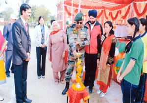 Brig Ajay K Chauhan and other dignitaries lighting ceremonial lamp while inaugurating annual sports day at KV Nagrota on Saturday.