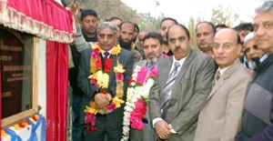 Minister for Floriculture, Syed Mohammad Altaf Bukhari flanked by Minister for Agriculture, Ghulam Nabi Lone Hanjura inaugurating bridge in Chrar-e-Sharief constituency on Wednesday.