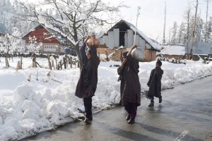 Despite heavy snowfall, women carry drinking water on heads at village Heerpora in Shopian district on Friday. -Excelsior/ Younis Khaliq