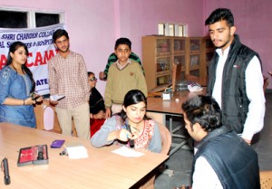 A doctor prescribing medicines to a patient during a medical camp at Sainik Colony, Jammu.
