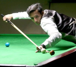 Cueist  aiming a shot during a match of State Junior Snooker Championship at Billiards Hall, MA Stadium on Tuesday. -Excelsior/ Rakesh