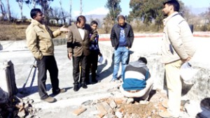Crime Branch team lifting samples of material used in construction of Govt Degree College, Mendhar on Tuesday.