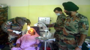 An Army doctor examining a patient during a multi specialty camp at Nowshera in Rajouri.