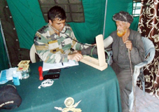 A patient being examined by an Army doctor during a medical camp. 