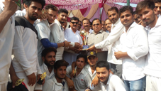 Digintaries awarding Jai Baba Birfa Nath Ji Premium League Tournament title trophy to winning team.