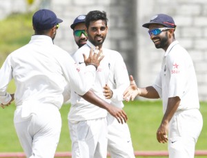 Bhuvneshwar Kumar (C) celebrates with Ajinkya Rahane (R) of India taking 5 West Indies wickets for 33 runs during day 4 of the 3rd Test between West Indies and India on August 12, 2016 at Darren Sammy National Cricket Stadium Gros Islet, St. Lucia. / AFP / Randy BROOKS        (Photo credit should read RANDY BROOKS/AFP/Getty Images)