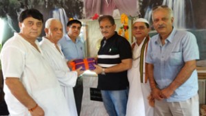 Speaker Kavinder Gupta being presented a set of books by Pt. Omkar Nath Shastri at a function at Gole Gujral on Friday.