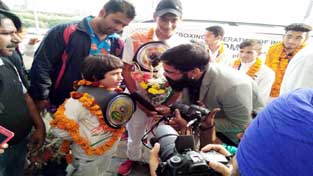 Young kick-boxer Tajamu Islam being received by a galaxy of dignitaries at Indira Gandhi International Airport, Delhi after returning from Italy.